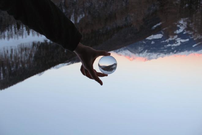 A person holding a black-and-white ball